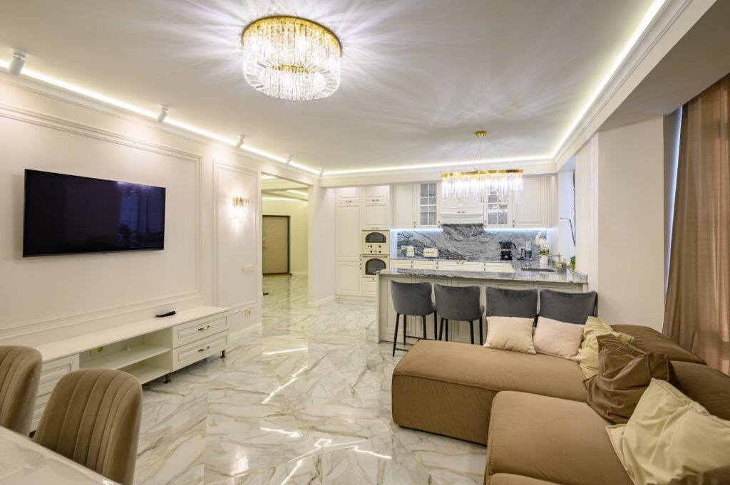 Studio apartment featuring classic kitchen with island, and wall-mounted TV set